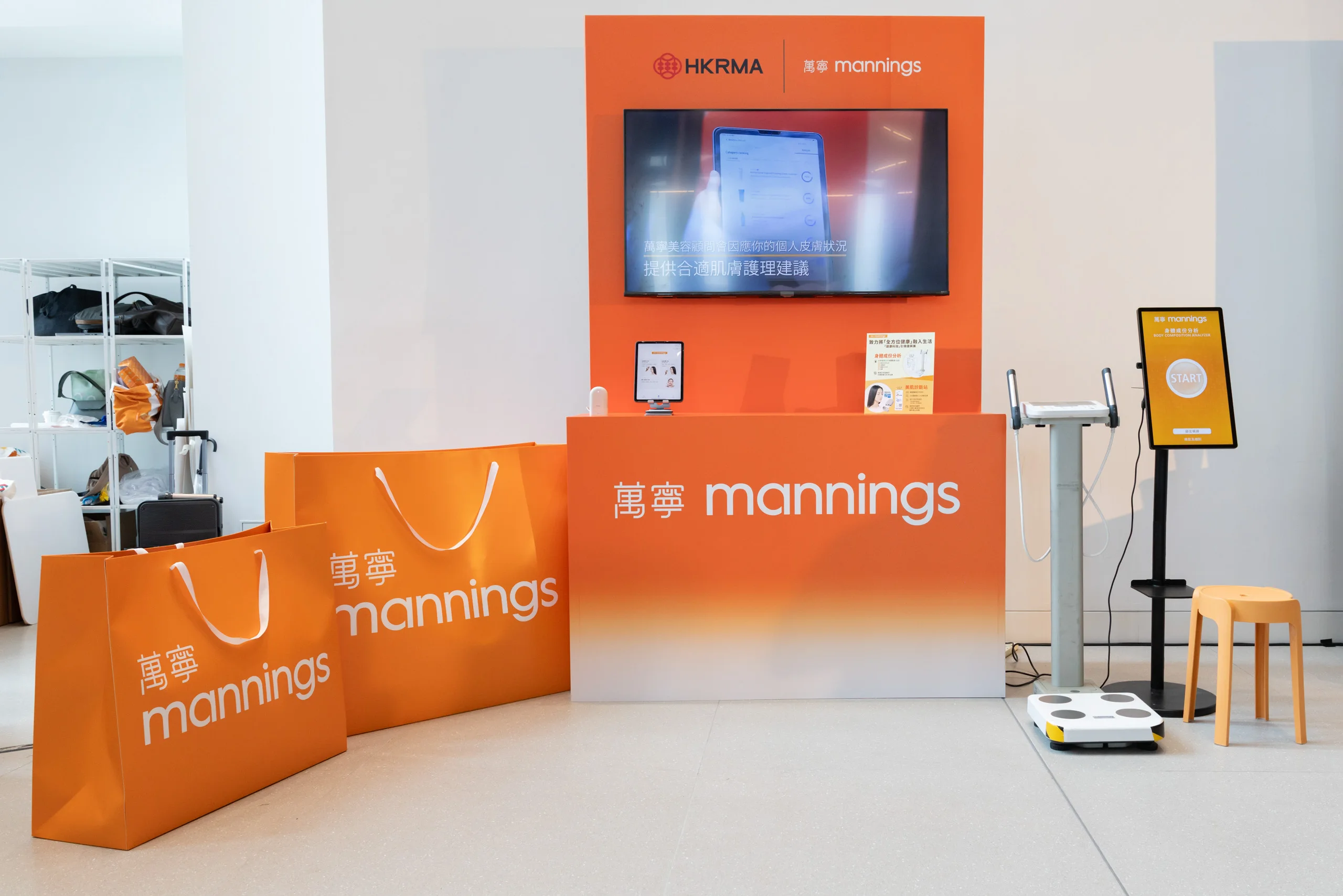 Mannings brand event set with orange shopping bags — brand event photography by Kenn Photographic Arts