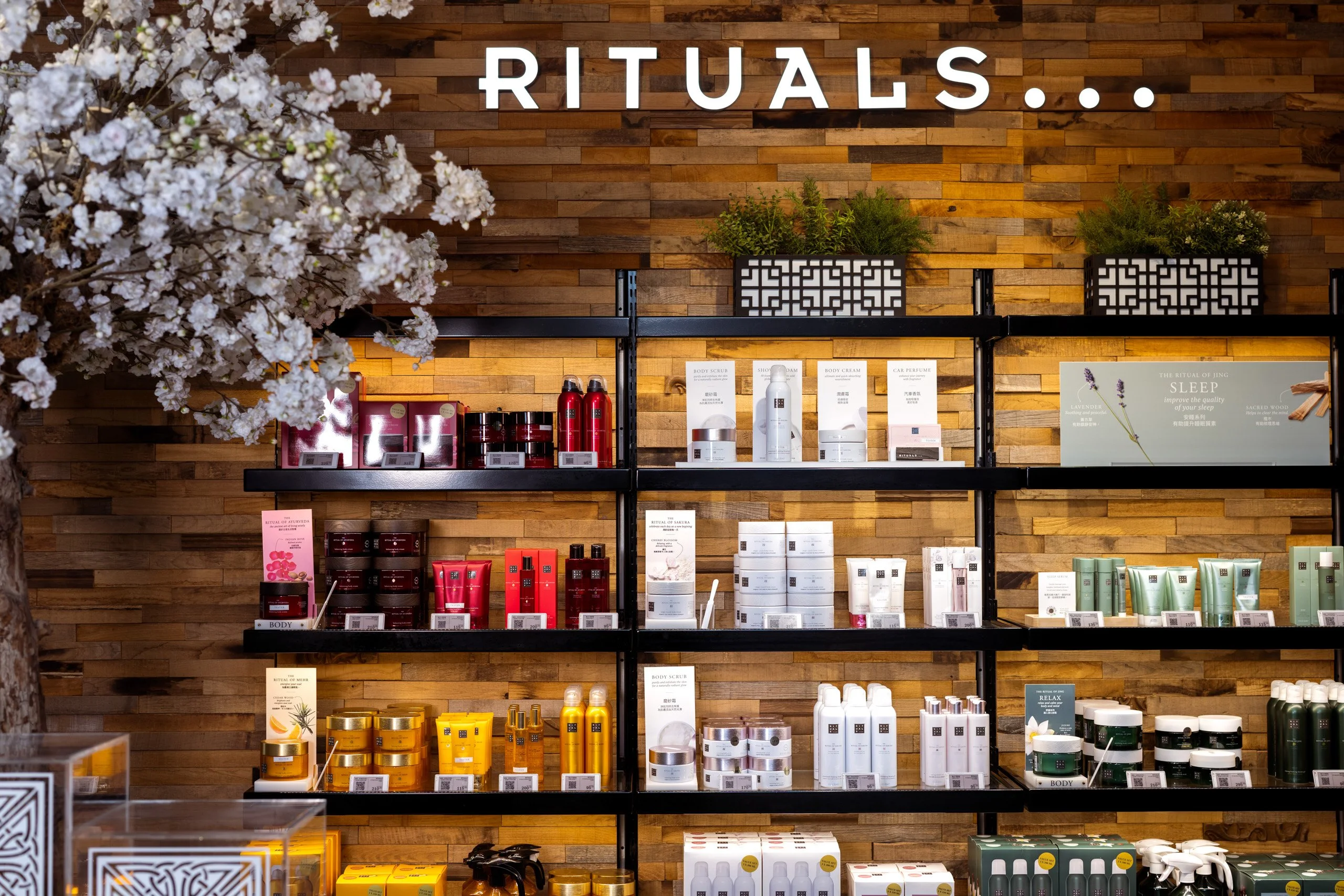 Rituals product wall framed by cherry blossom — retail photography by Kenn Photographic Arts