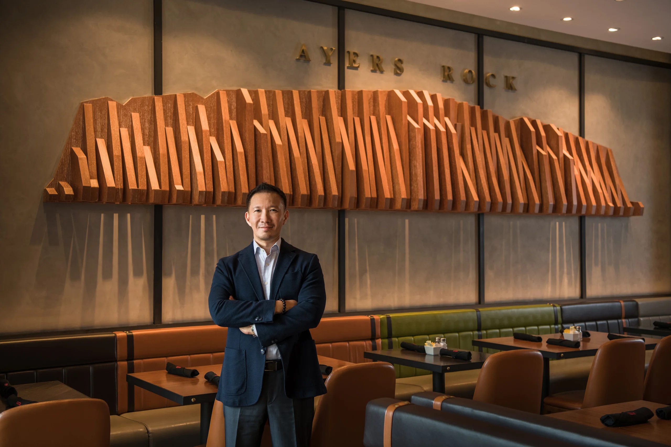 Executive portrait inside Ayers Rock restaurant — corporate portrait photography by Kenn Photographic Arts