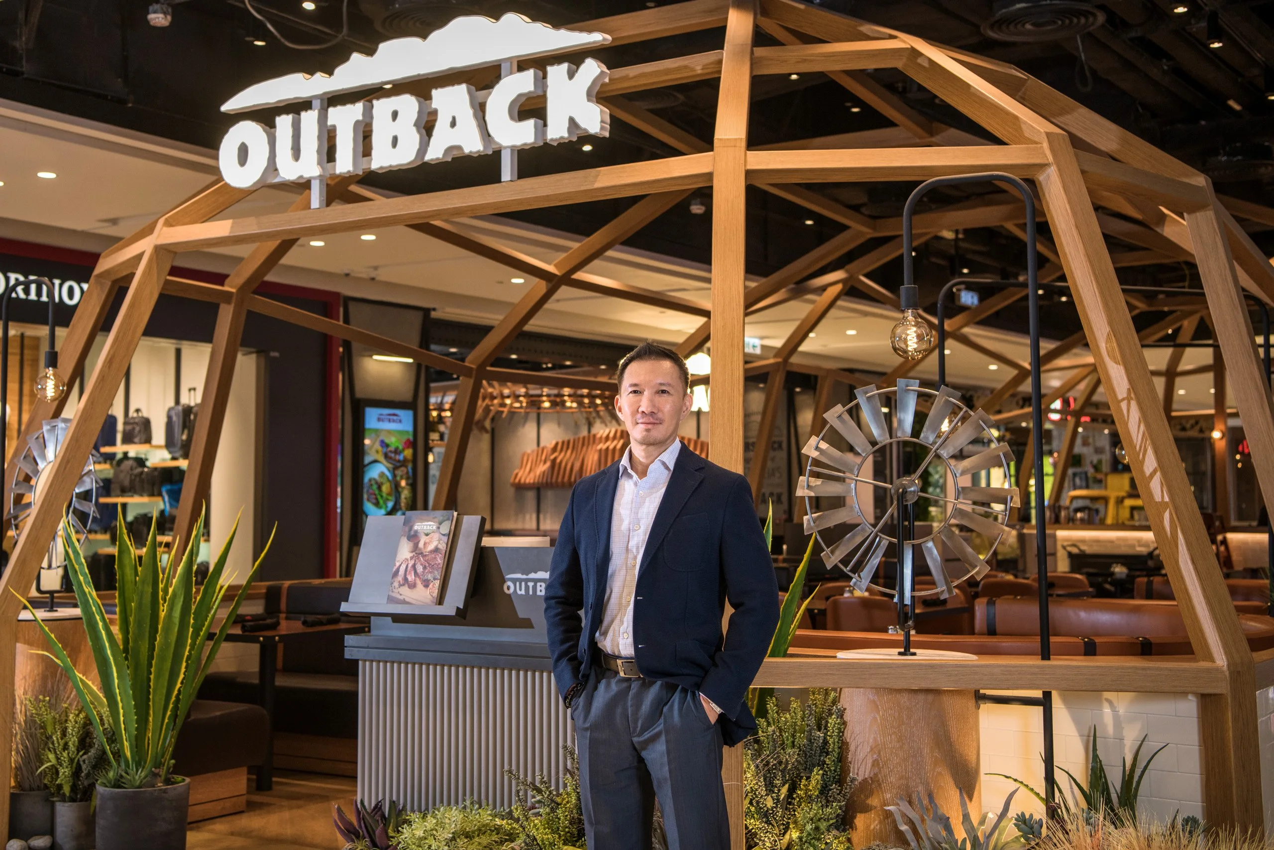 Executive portrait at the Outback restaurant entrance — corporate portrait photography by Kenn Photographic Arts
