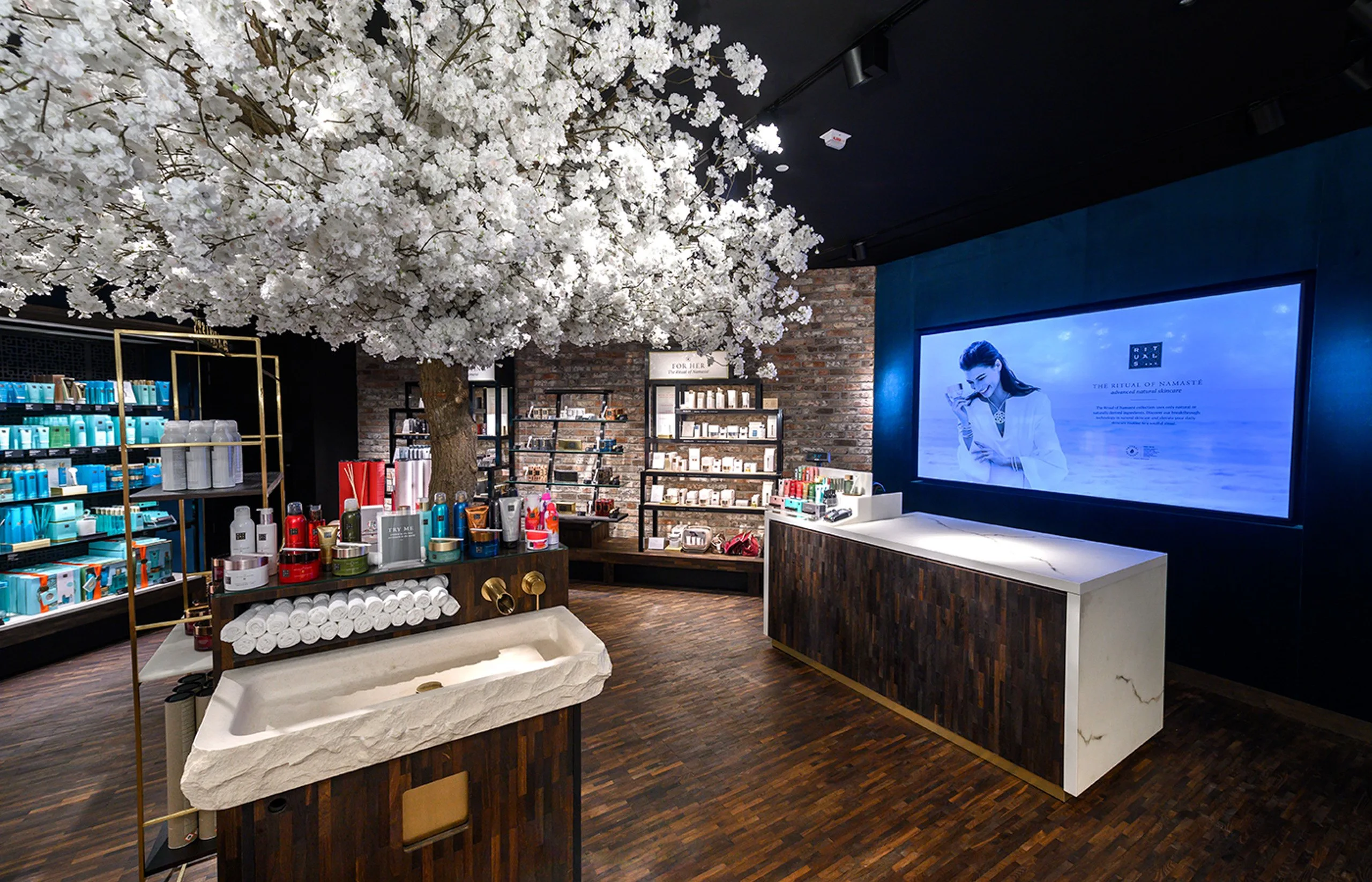 Rituals store interior with a white blossom tree installation — retail photography by Kenn Photographic Arts