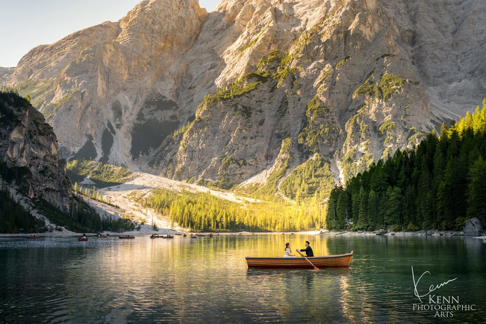Mable & Hon rowing across the lake beneath the Dolomite mountains — Dolomites pre-wedding by Kenn Photographic Arts