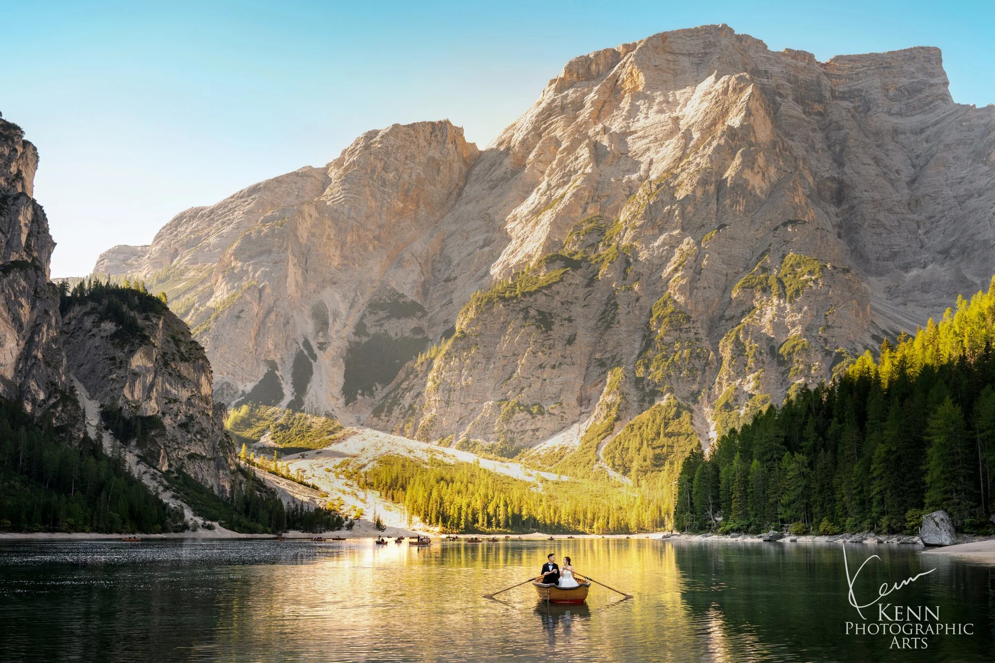 Golden-hour panorama of Lago di Braies with a small rowboat on the lake — Dolomites pre-wedding by Kenn Photographic Arts