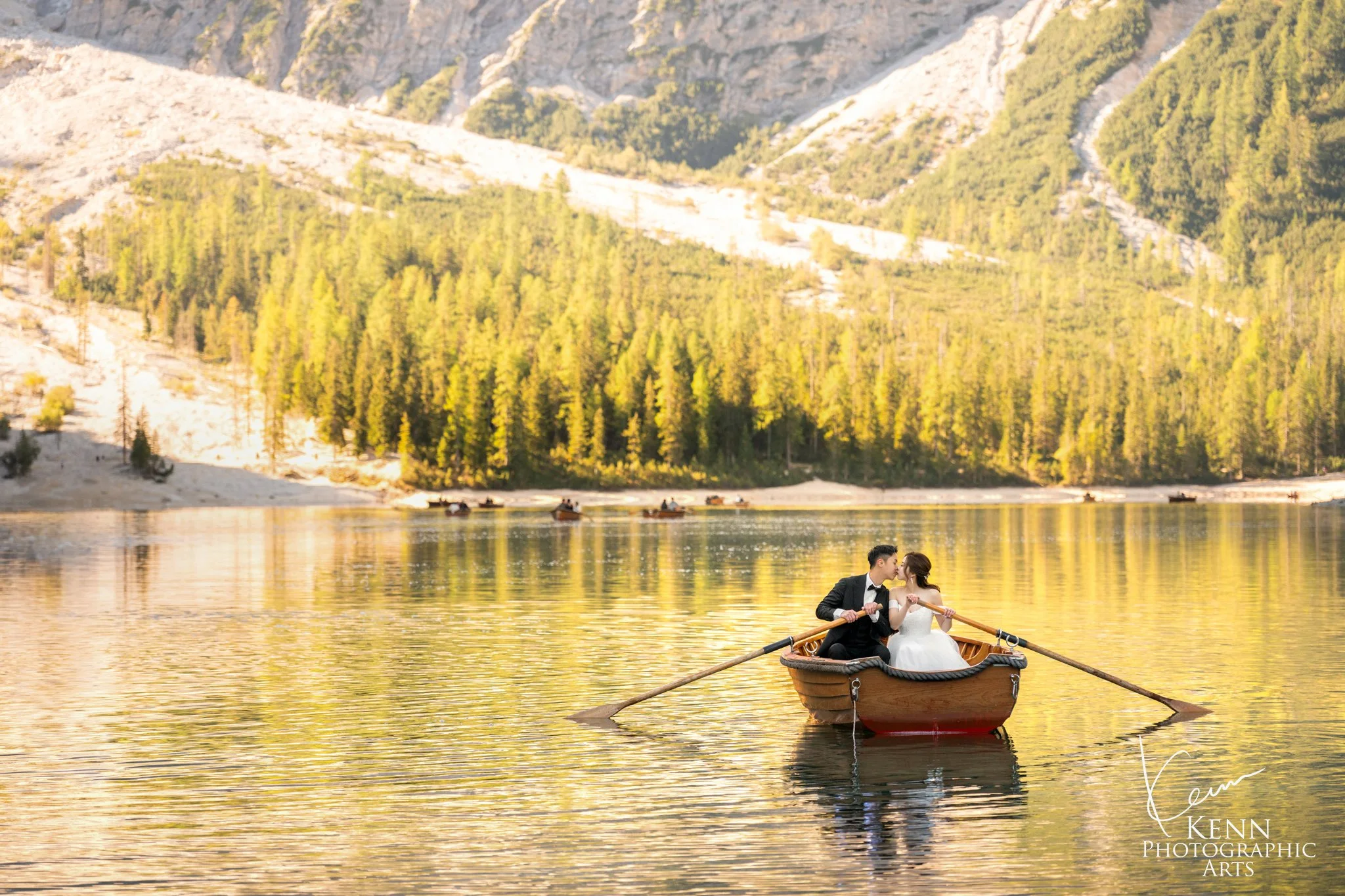 Mable & Hon rowing on golden water at sunrise — Dolomites pre-wedding by Kenn Photographic Arts