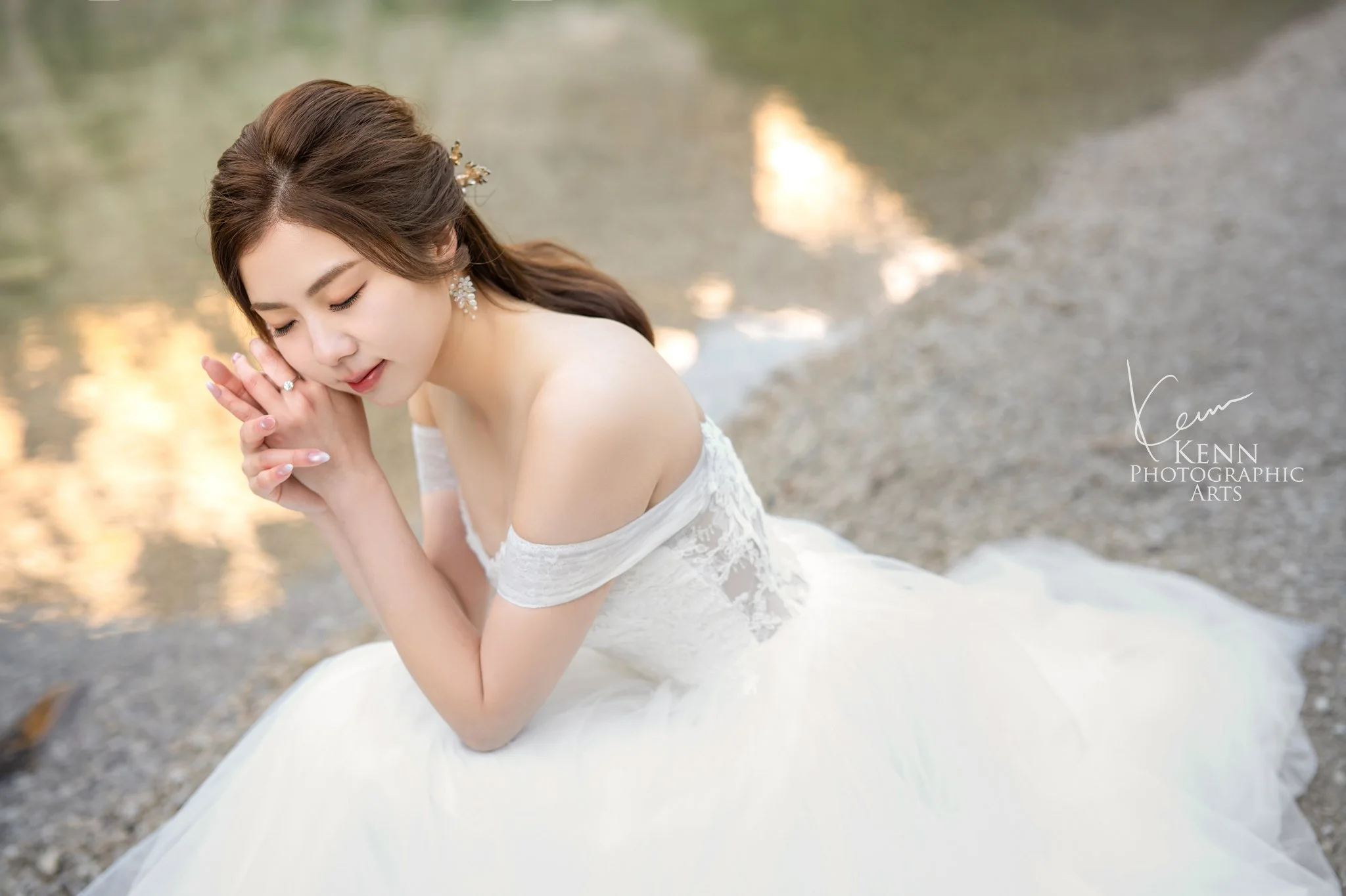 Bridal portrait of Mable seated on the shore of Lago di Braies — Dolomites pre-wedding by Kenn Photographic Arts