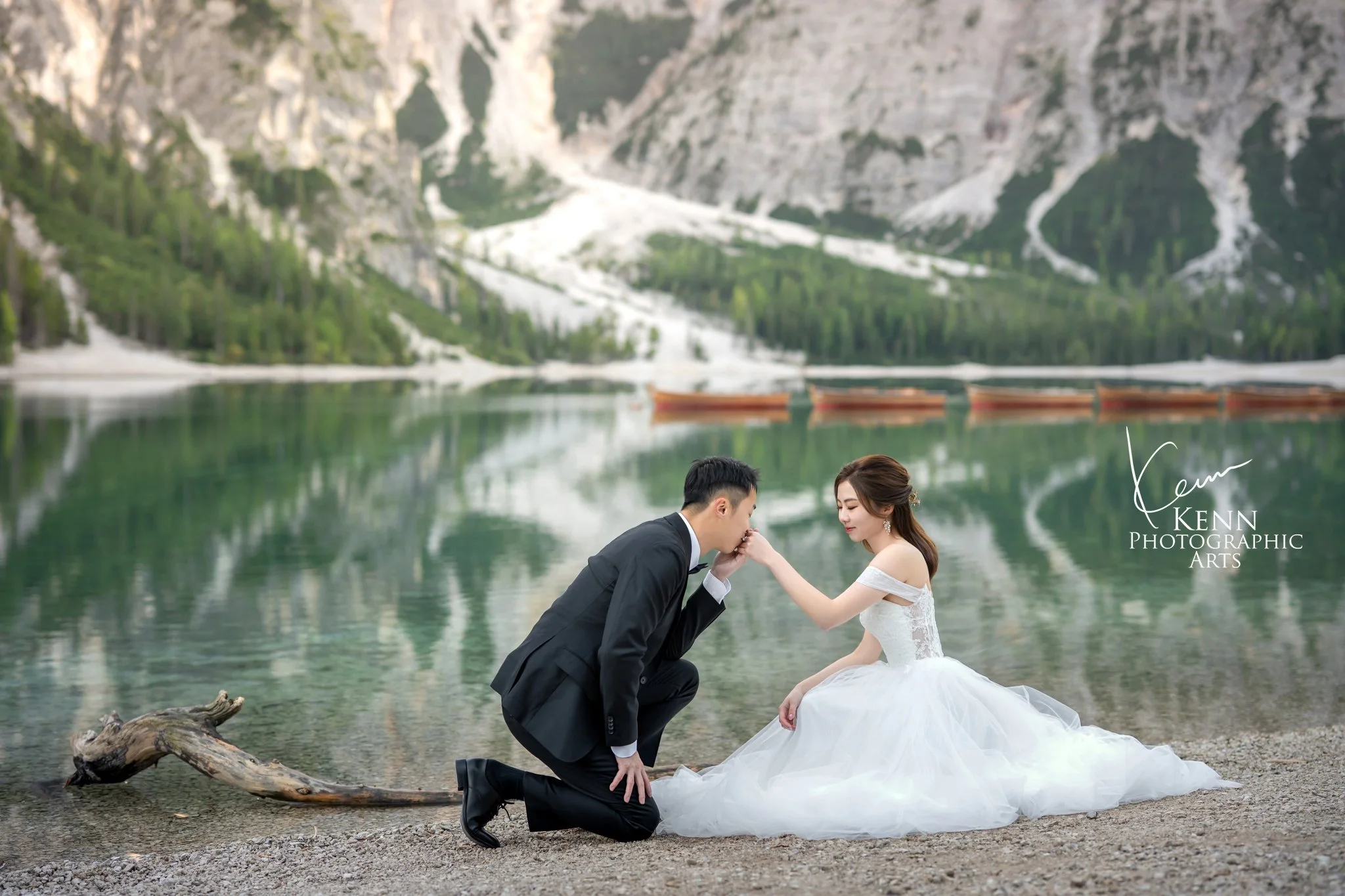 Bridal portrait by Lago di Braies, hands resting under her chin — Dolomites pre-wedding by Kenn Photographic Arts