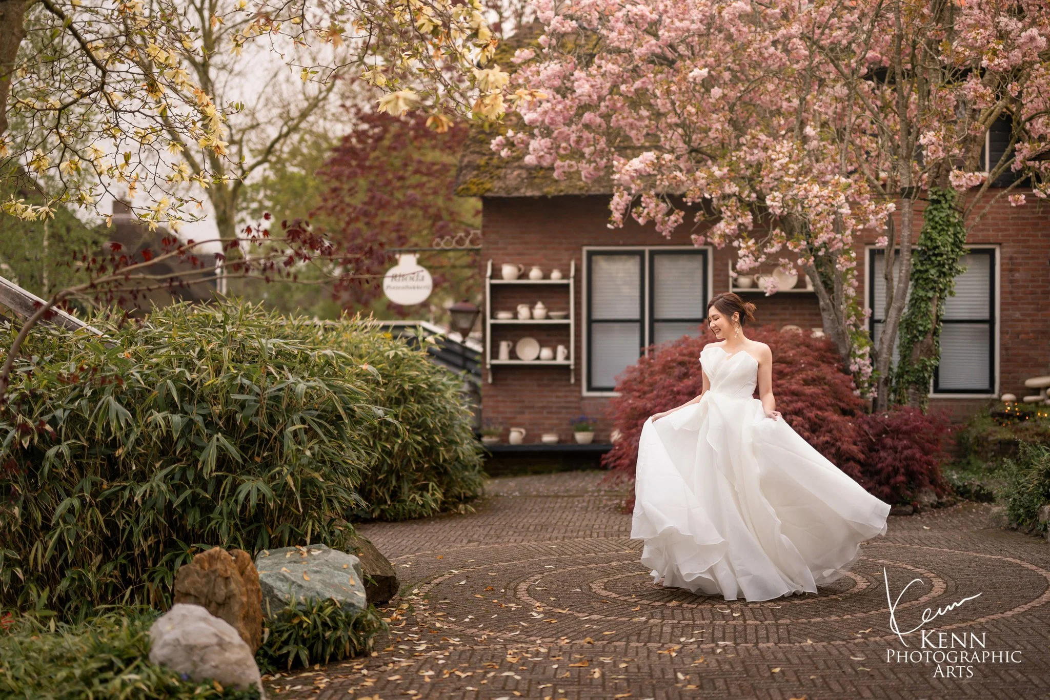 Bride twirling in a cottage garden in Giethoorn — Netherlands pre-wedding by Kenn Photographic Arts
