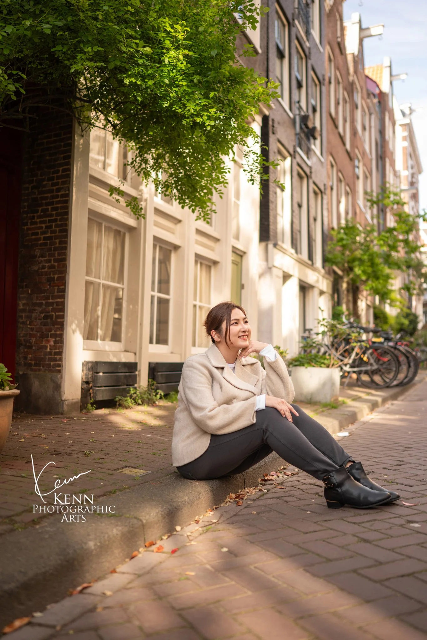 Michelle sitting on a quiet Amsterdam street lined with greenery — Netherlands pre-wedding by Kenn Photographic Arts